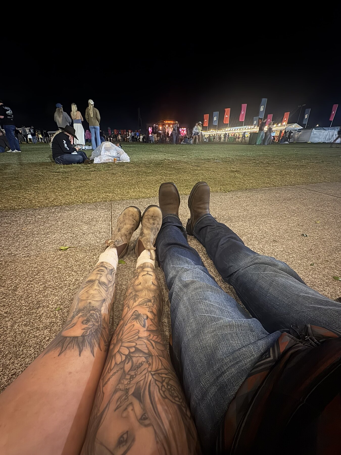 Two pairs of boots stretched out on the grass at Strummingbird
