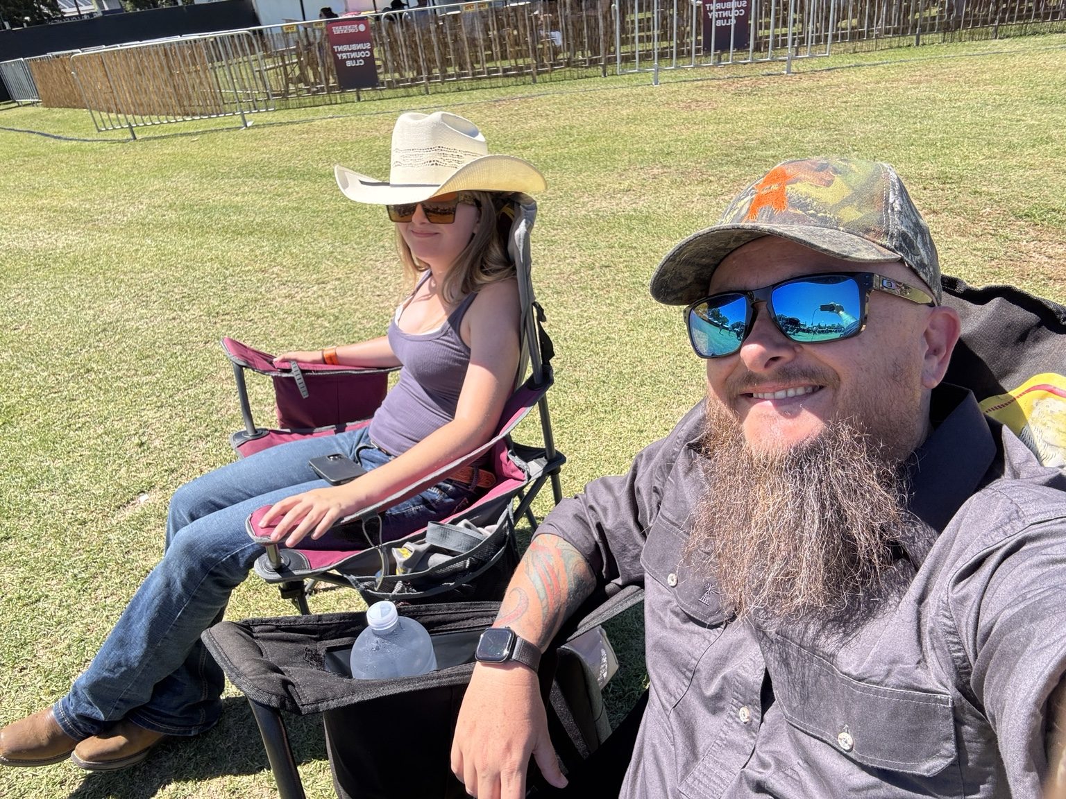 Shane and Zoe relaxing in camp chairs at Sunburnt Country 2026